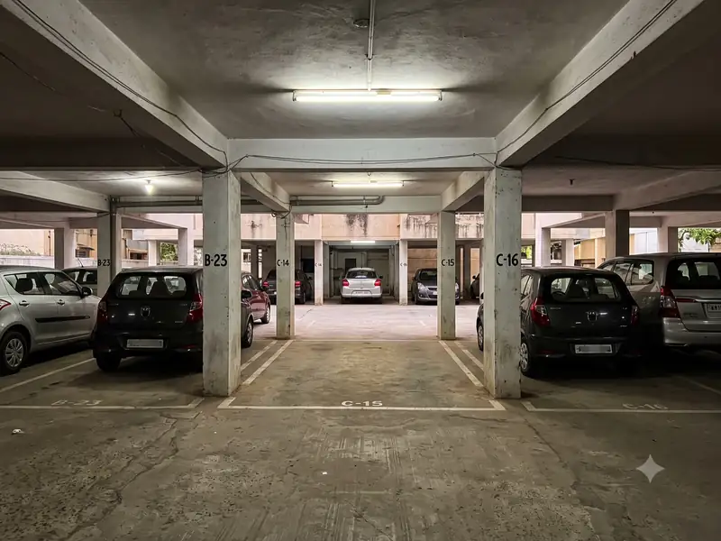Apartment stilt parking with cars parked between concrete pillars