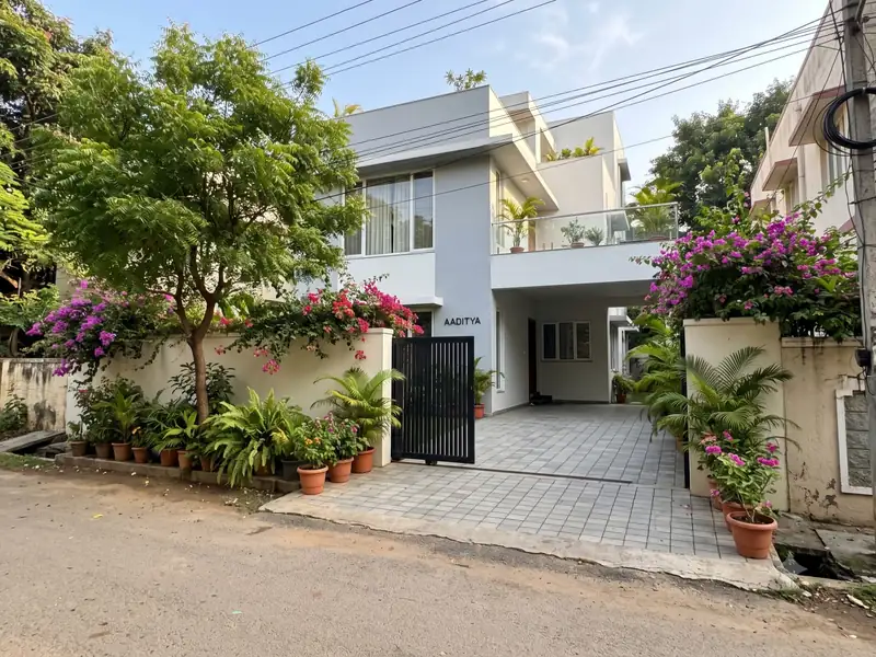 Independent house with a paved driveway, gate and flowering plants